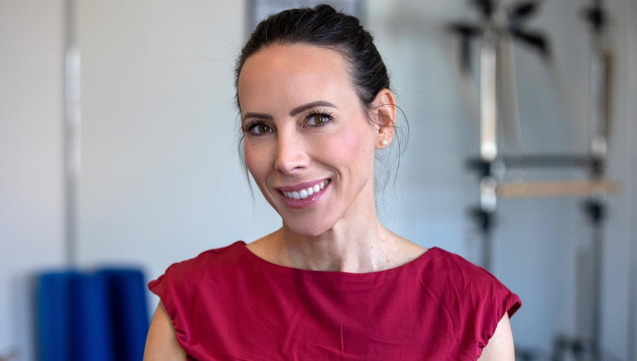 Smiling instructor at Firefly Pilates, Potters Bar, England, GB. Enhancing your wellness journey.