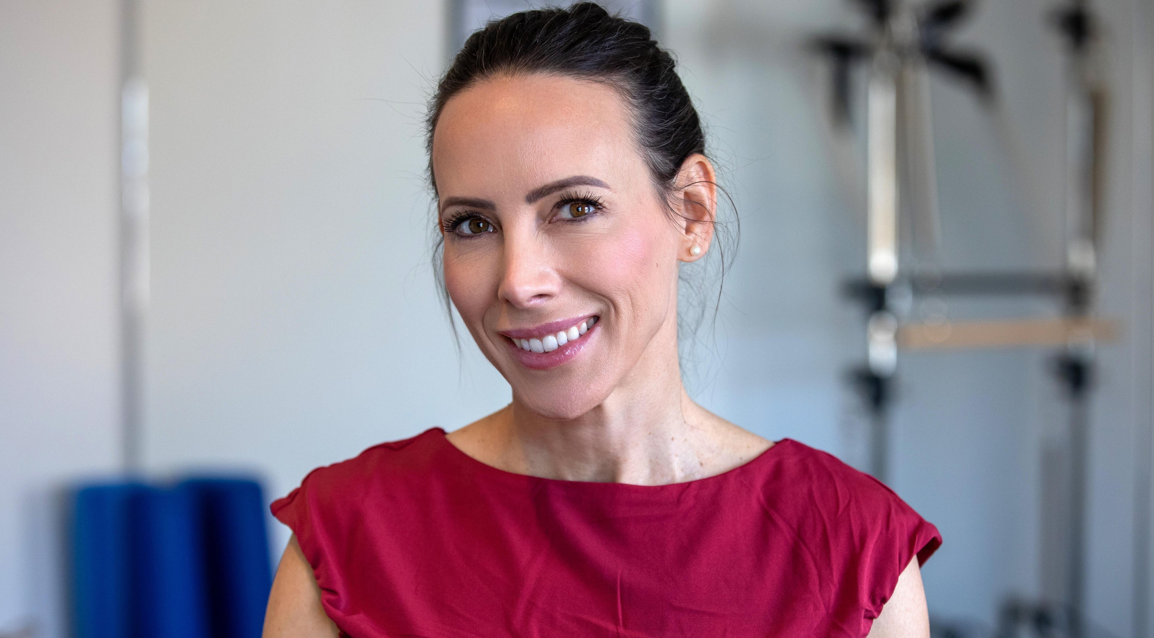 Smiling instructor at Firefly Pilates, Potters Bar, England, GB. Enhancing your wellness journey.