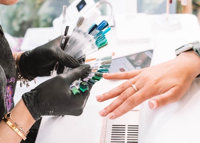 Client selects nail color at Sacred Roots Limited, Guernsey, Vale, GG for customized manicure.