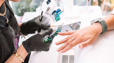 Client selects nail color at Sacred Roots Limited, Guernsey, Vale, GG for customized manicure.