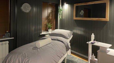 Relaxing treatment room at Sacred Roots Limited, Guernsey, Vale, GG with cozy bed and soothing ambiance.