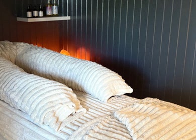 Tranquil massage bed with plush towels at Sacred Roots Limited in Guernsey, Vale, GG.
