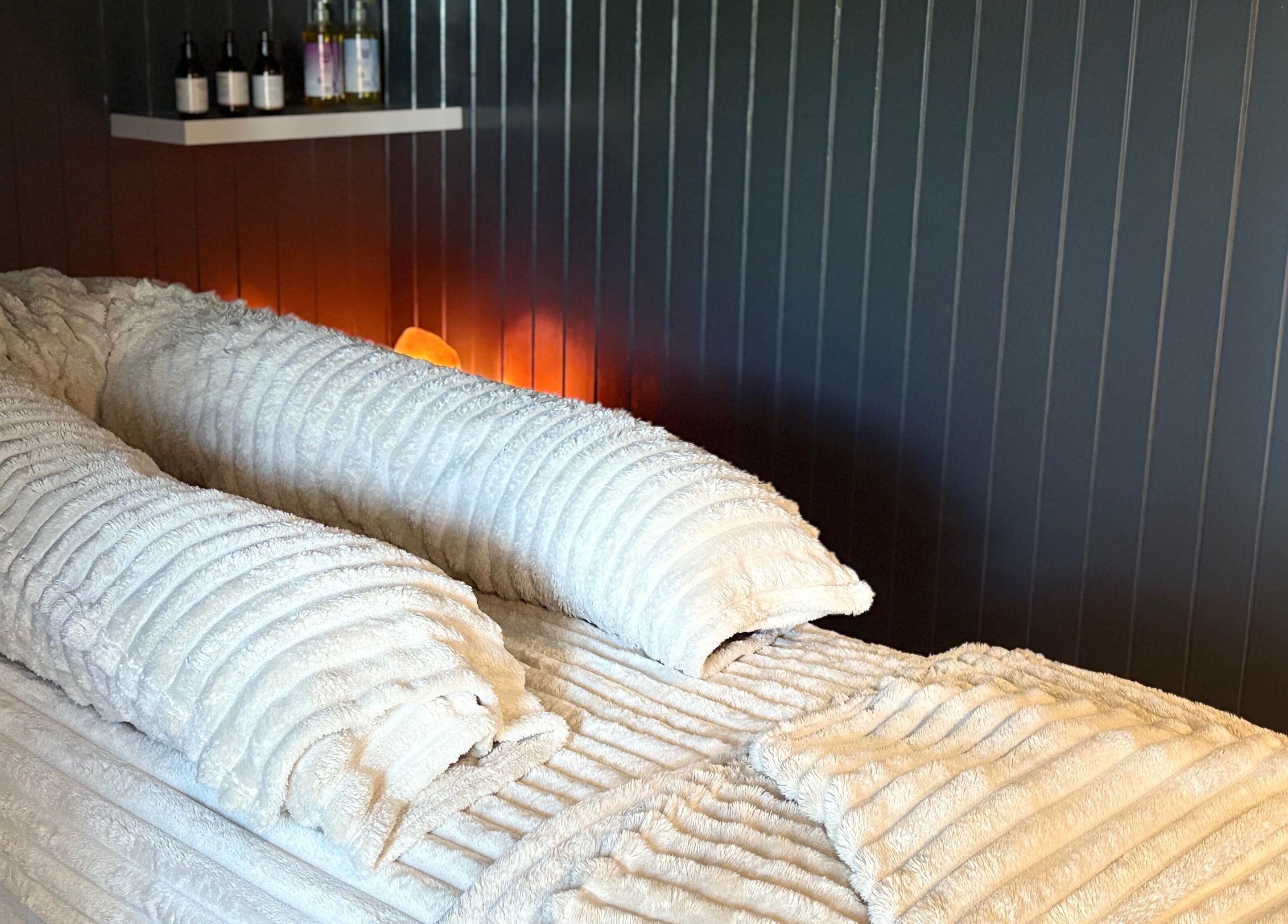 Tranquil massage bed with plush towels at Sacred Roots Limited in Guernsey, Vale, GG.