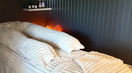 Tranquil massage bed with plush towels at Sacred Roots Limited in Guernsey, Vale, GG.