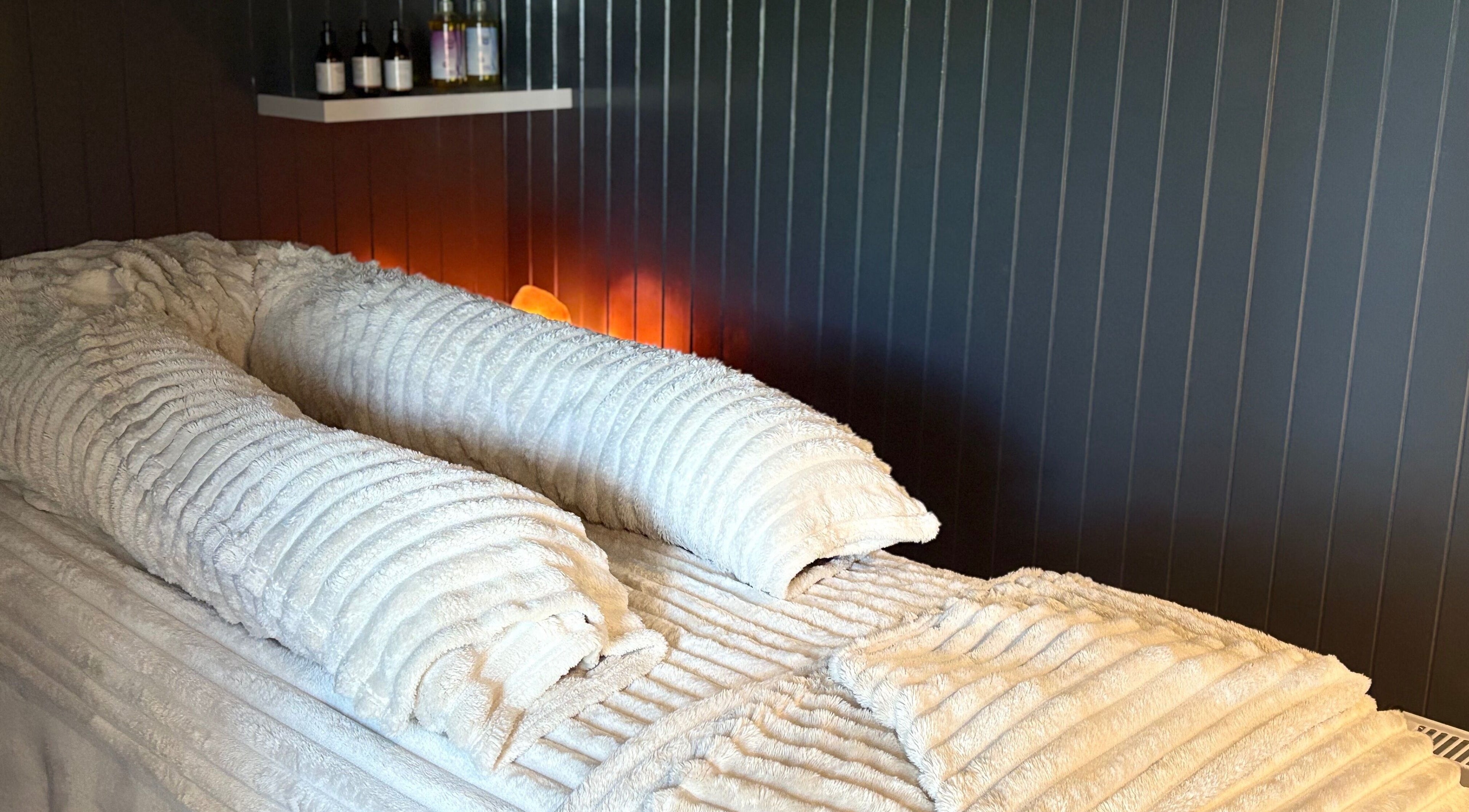 Tranquil massage bed with plush towels at Sacred Roots Limited in Guernsey, Vale, GG.