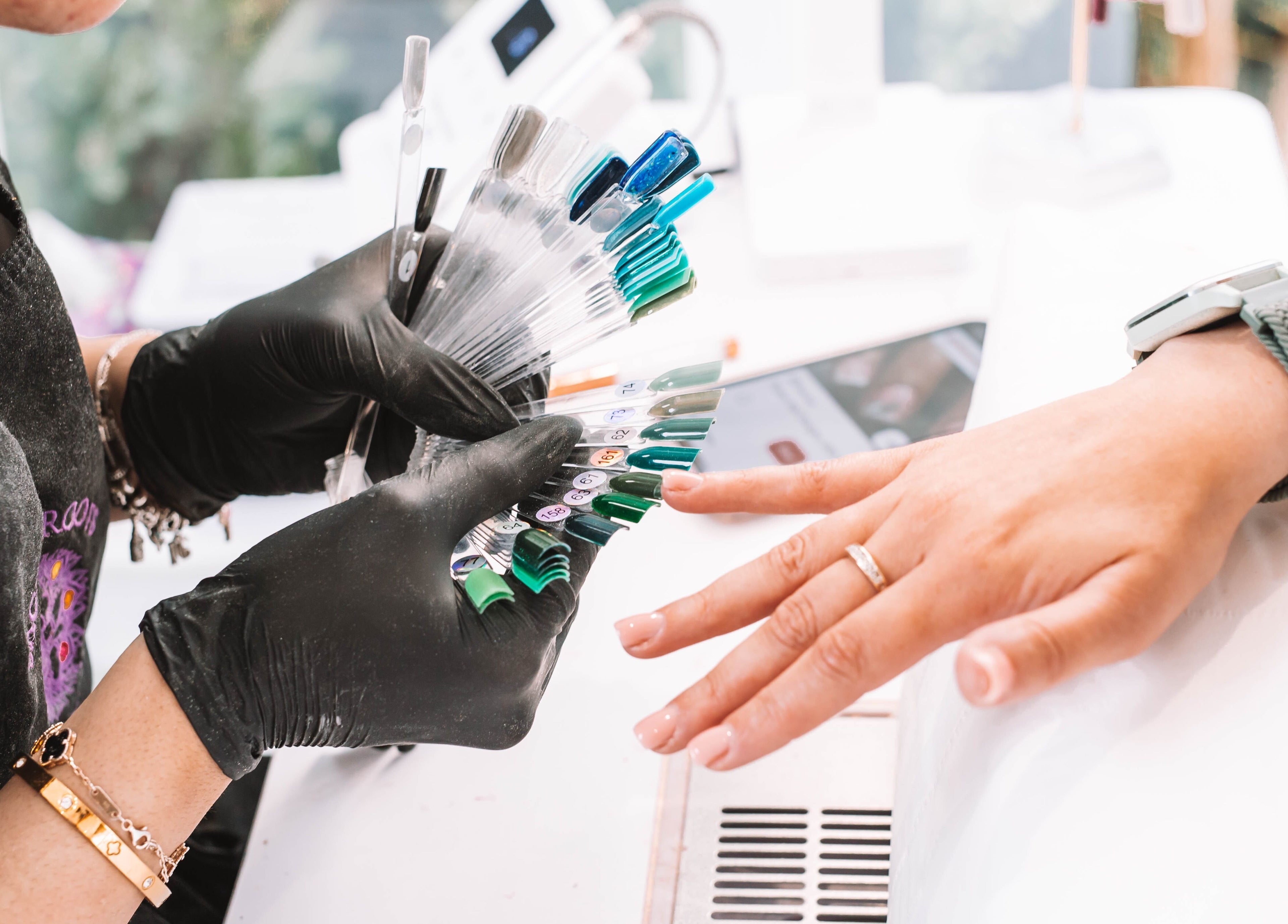 Nail artist at Sacred Roots Limited in Guernsey, Vale, GG showcasing color options.