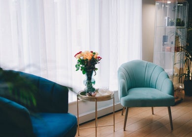 Cozy seating area with teal chairs at Glam and Glow Beauty Lab, Hockley Heath, England, GB, perfect for relaxation.