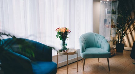 Cozy seating area with teal chairs at Glam and Glow Beauty Lab, Hockley Heath, England, GB, perfect for relaxation.