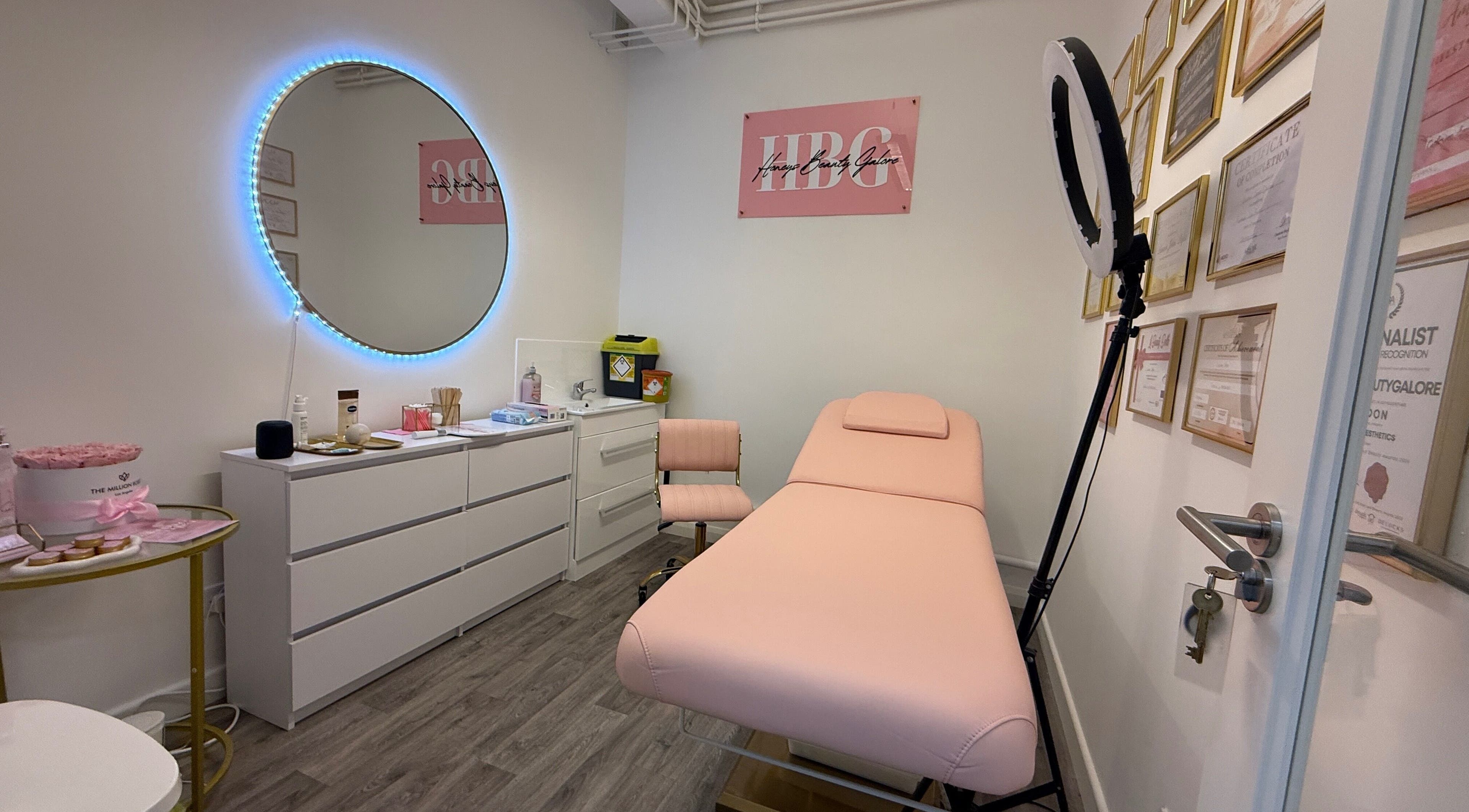 Tranquil room at Honeys Beauty Galore, London, England, GB with elegant decor and pink treatment bed.