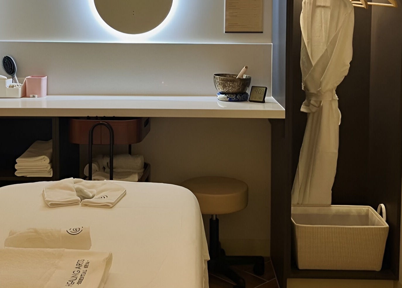 Relaxing treatment room at Healing Arts Essential Spa, Melbourne, Victoria, AU, with warm ambiance and robes.