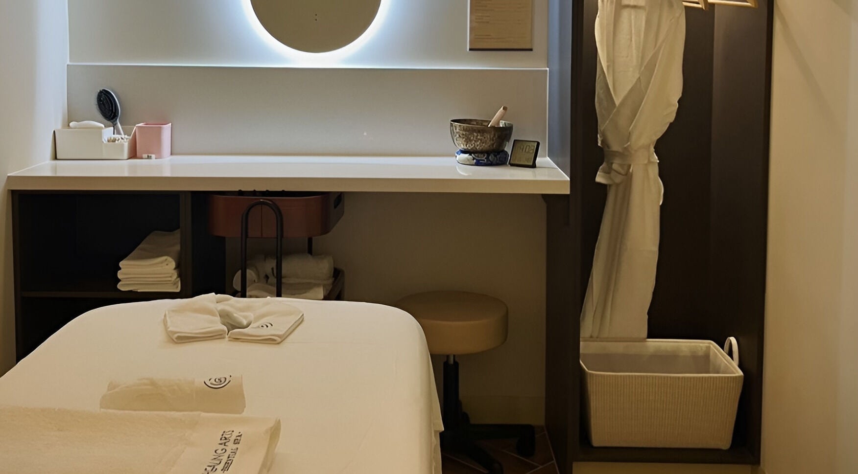 Relaxing treatment room at Healing Arts Essential Spa, Melbourne, Victoria, AU, with warm ambiance and robes.