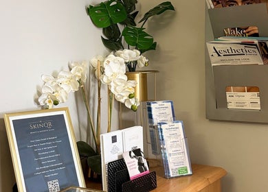 Elegant display at V Fritz Lymphatic Drainage Specialist in London, GB, showcasing skincare brochures and white orchids.