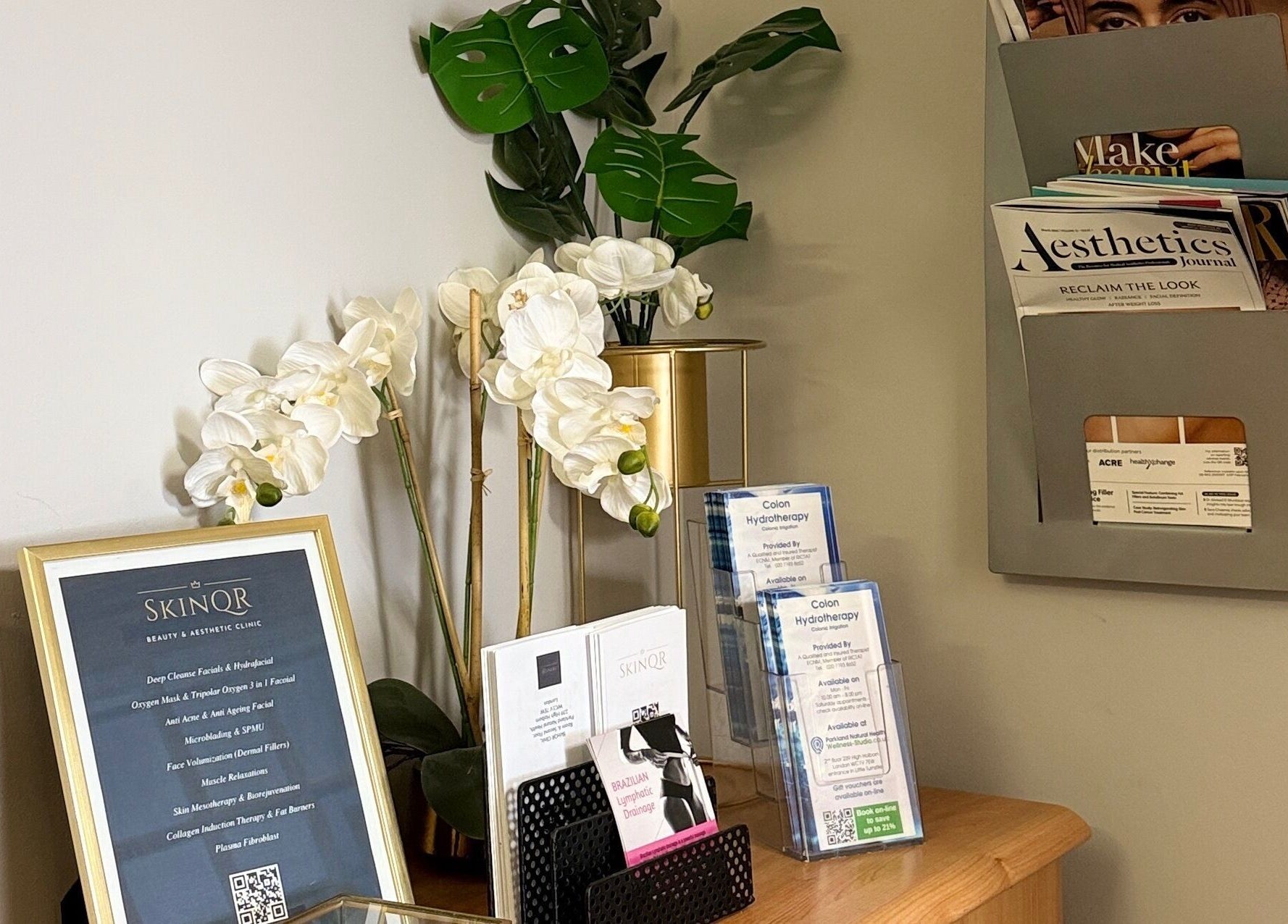 Elegant display at V Fritz Lymphatic Drainage Specialist in London, GB, showcasing skincare brochures and white orchids.