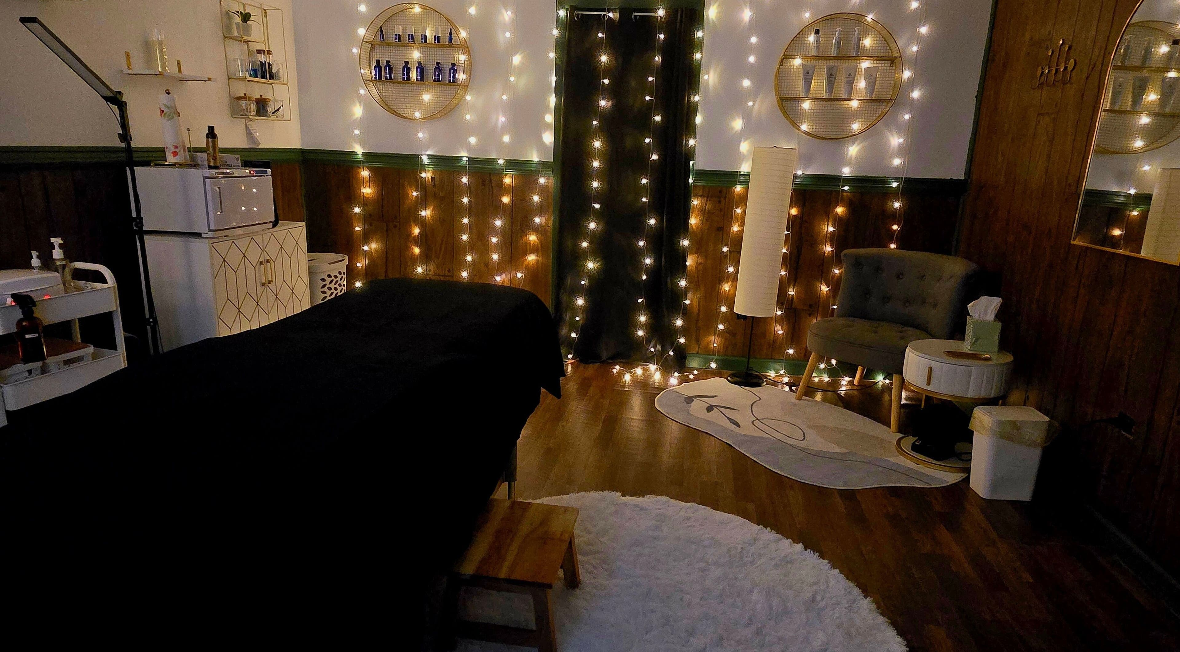 Elegant treatment room at Skin Deep Studio, Remus, Michigan, US, showcasing ambient lighting and cozy decor.