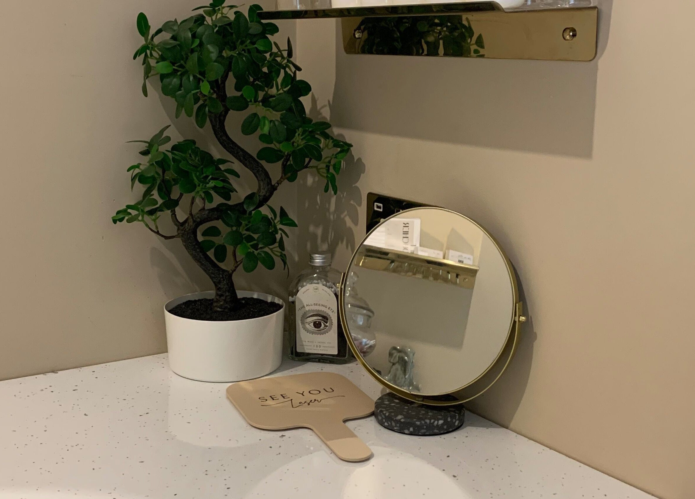 Chic vanity space at See You Laser, Havant, England, GB with a potted plant and mirror.