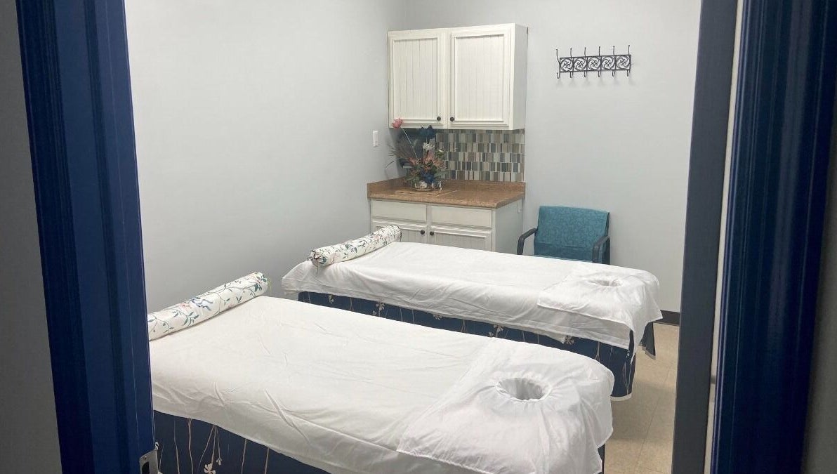 Relaxing massage room at Revive Asian Massage, Overland Park, Kansas, US with two massage tables.