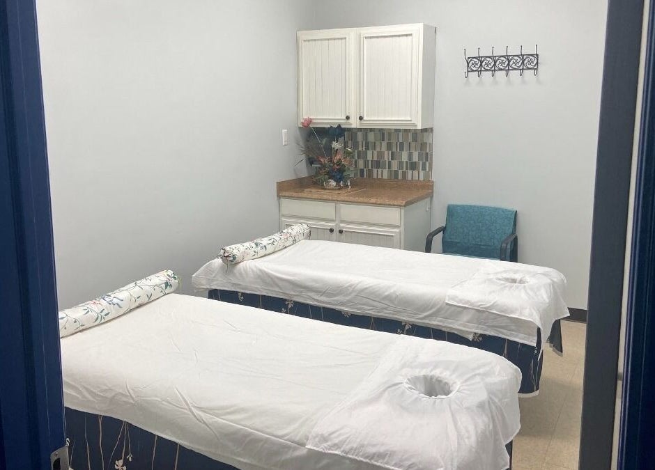 Relaxing massage room at Revive Asian Massage, Overland Park, Kansas, US with two massage tables.