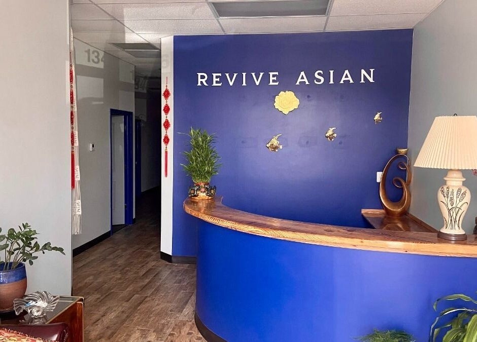 Reception area at Revive Asian Massage in Overland Park, Kansas, US, featuring a calming blue desk.
