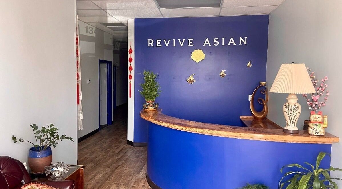 Reception area at Revive Asian Massage in Overland Park, Kansas, US, featuring a calming blue desk.