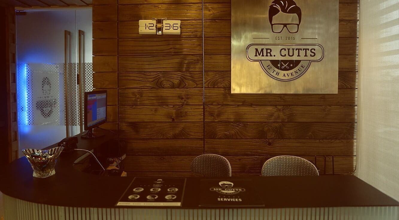 Reception area of Mr Cutts, Dhaka, Dhaka Division, BD with wooden decor and branding sign.