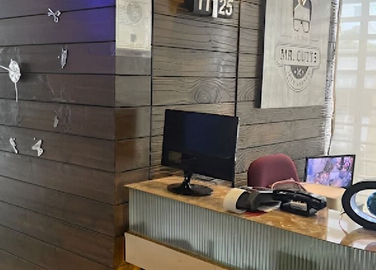 Reception desk at Mr Cutts, Dhaka, Dhaka Division, BD with modern decor and wall clock.