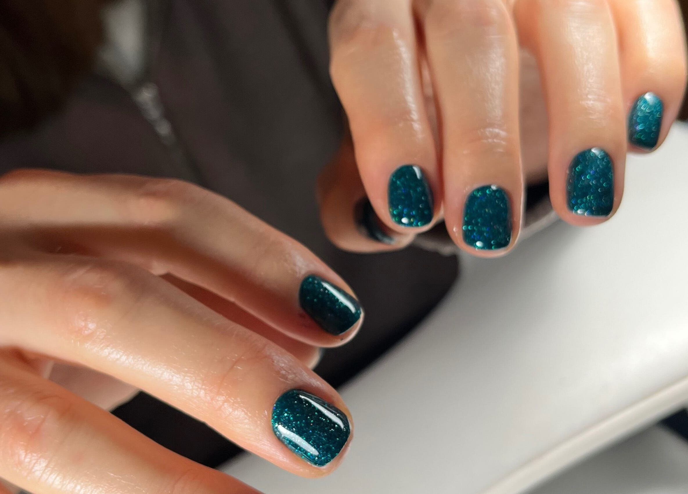 Glimmering teal manicure at Pooch 1 Creates in Bristol, England, GB showcasing stunning nail art.