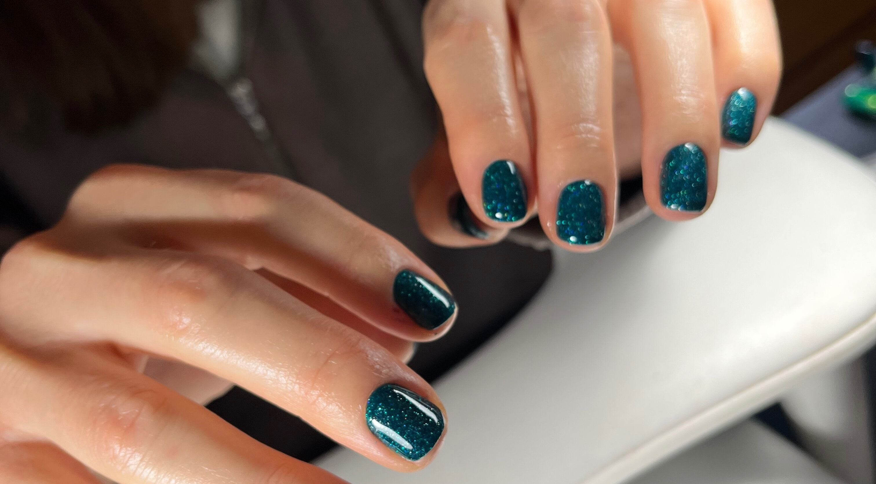 Glimmering teal manicure at Pooch 1 Creates in Bristol, England, GB showcasing stunning nail art.
