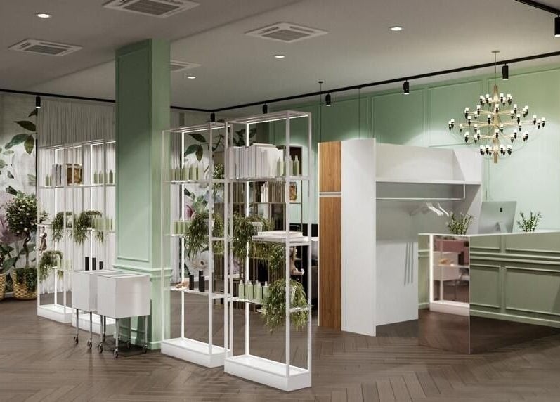 Ingresso elegante di Alchimie SAGL a Mendrisio, Ticino, CH con decorazioni verdi e design moderno.