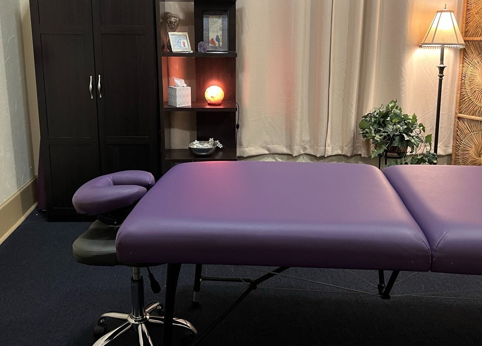 Comfortable massage room at Joanne's Nutrition World in Fort Pierce, Florida, US, featuring a purple massage table.