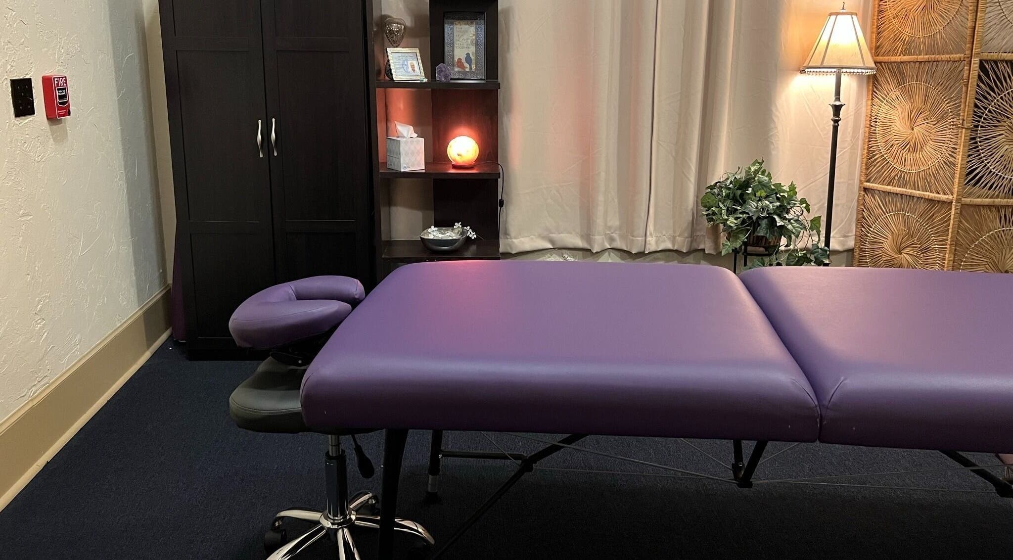 Comfortable massage room at Joanne's Nutrition World in Fort Pierce, Florida, US, featuring a purple massage table.