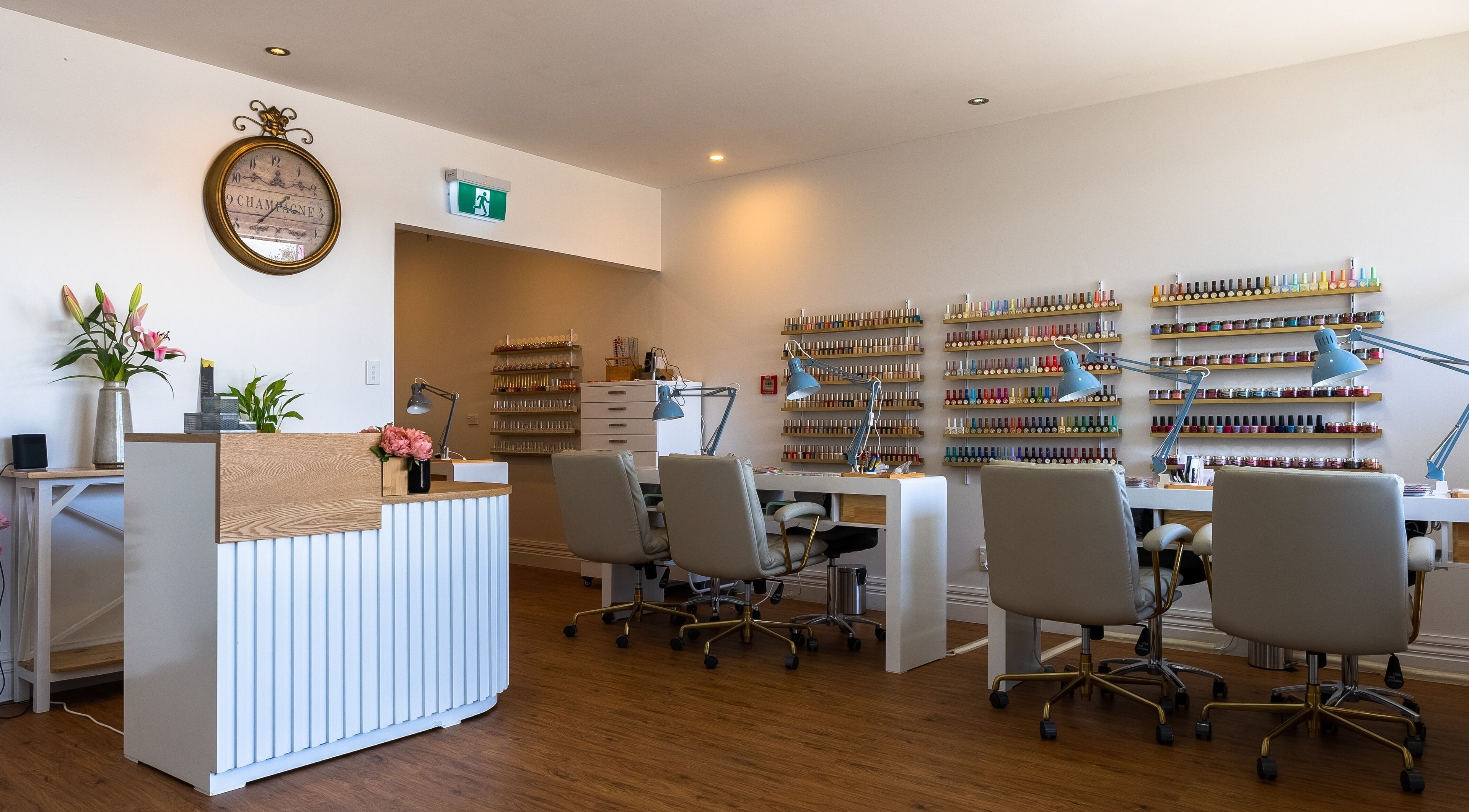 Modern nail salon at Nails and Beauty, Christchurch, Canterbury, NZ with stylish seating and polish collection.