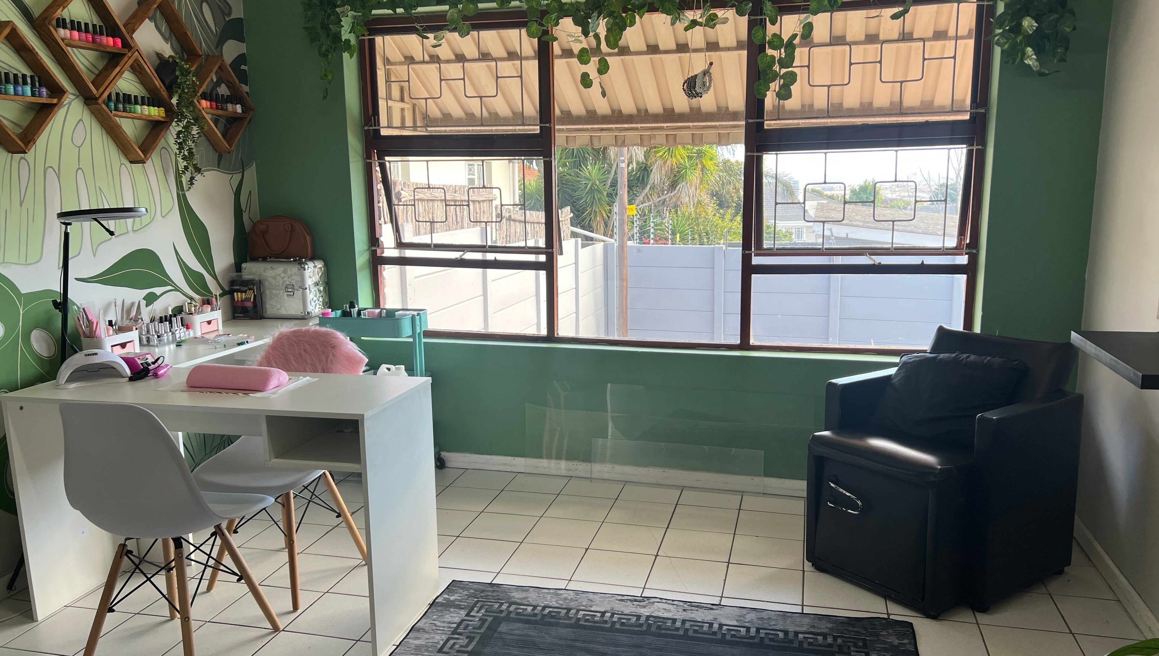 Bright nail salon area at The A List Beauty Salon, Gqeberha, Eastern Cape, ZA, with stylish decor and modern seating.
