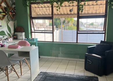 Bright nail salon area at The A List Beauty Salon, Gqeberha, Eastern Cape, ZA, with stylish decor and modern seating.