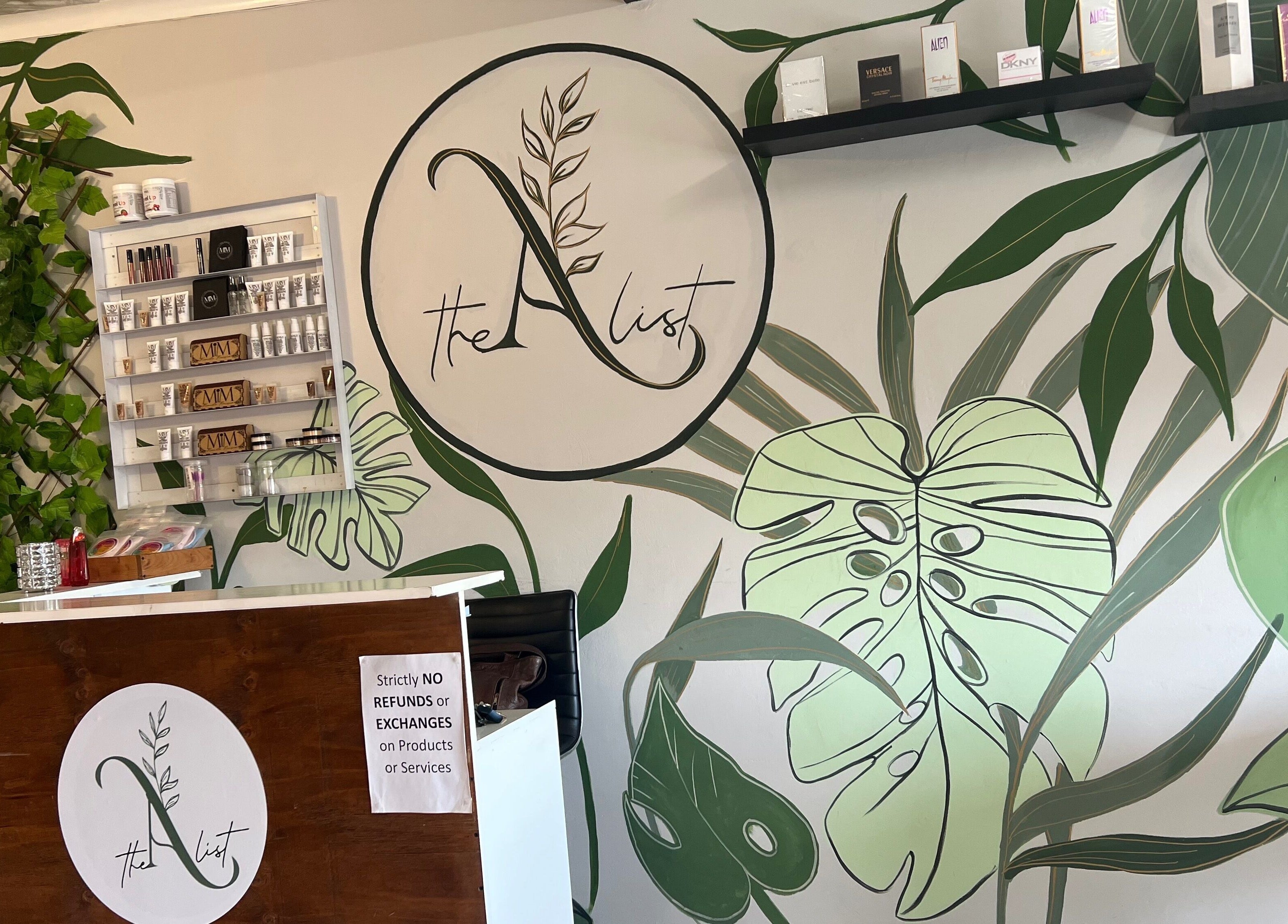 The A List Beauty Salon reception area with lush green decor in Gqeberha, Eastern Cape, ZA.