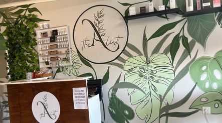 The A List Beauty Salon reception area with lush green decor in Gqeberha, Eastern Cape, ZA.