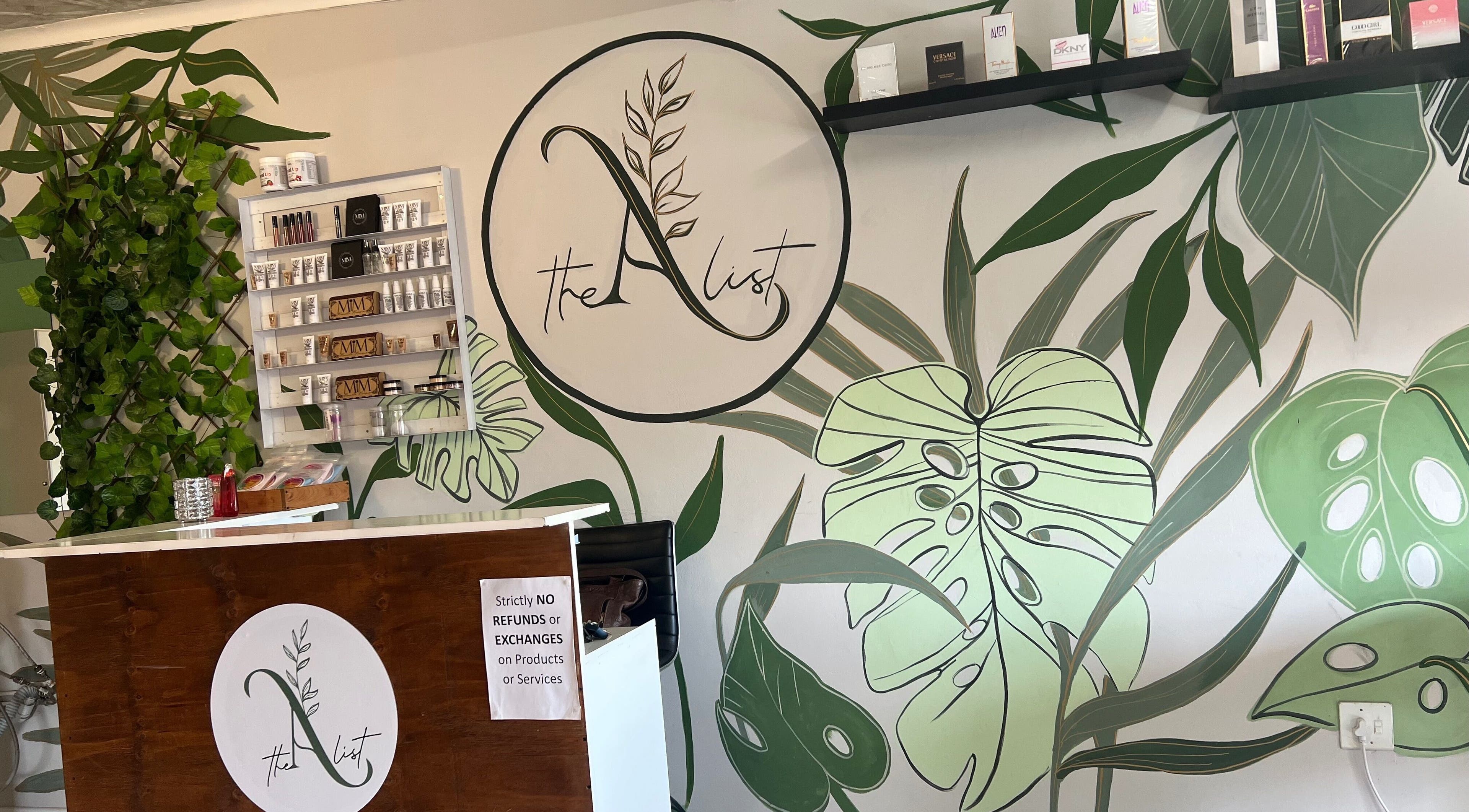 The A List Beauty Salon reception area with lush green decor in Gqeberha, Eastern Cape, ZA.