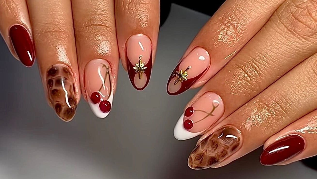 Elegant nail art at The Luxurious Lash Salon in Sharjah, Sharjah, AE featuring cherry and gold designs.