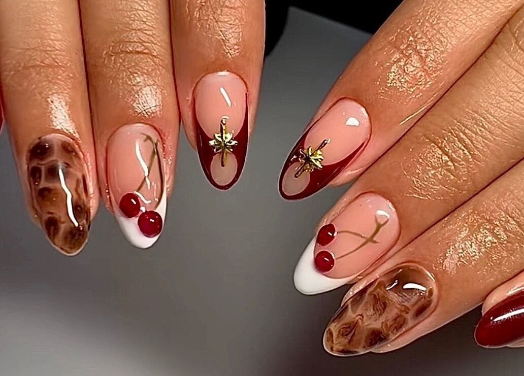 Elegant nail art at The Luxurious Lash Salon in Sharjah, Sharjah, AE featuring cherry and gold designs.