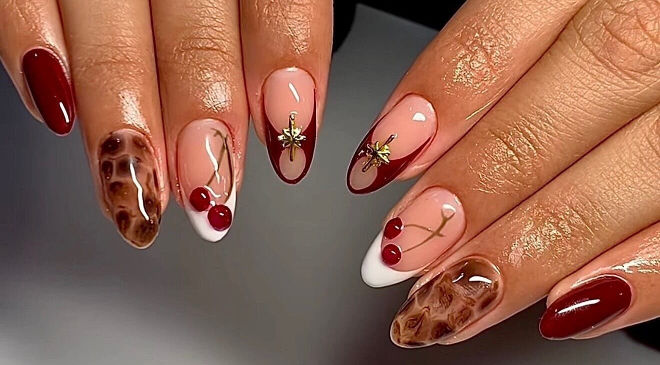 Elegant nail art at The Luxurious Lash Salon in Sharjah, Sharjah, AE featuring cherry and gold designs.