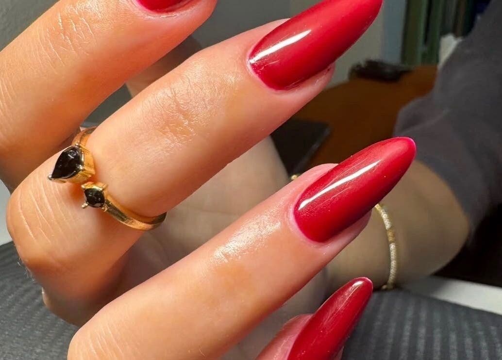 Close-up of vibrant red manicure at The Luxurious Lash Salon, Sharjah, Sharjah, AE.