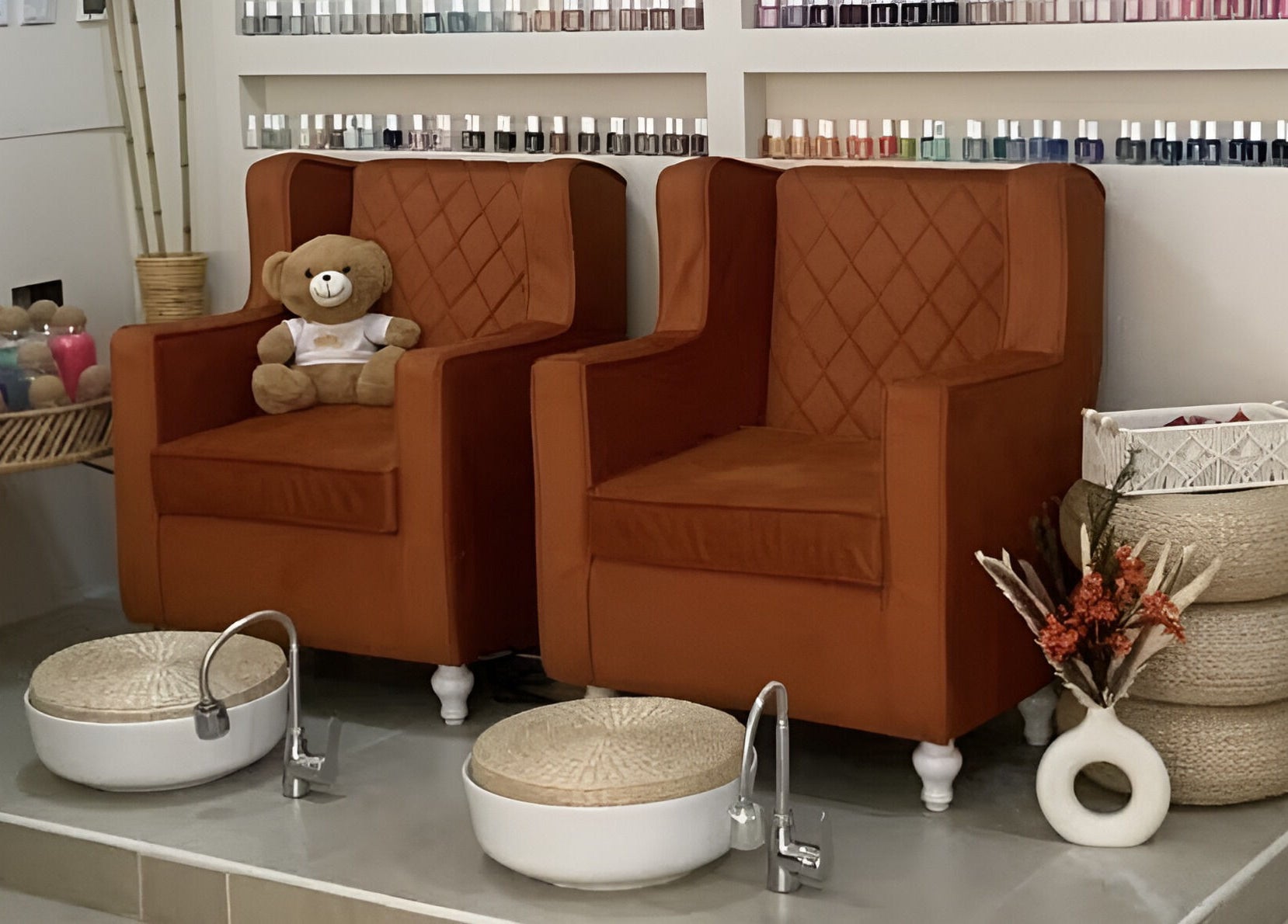 Warm pedicure chairs at Luxurious Lash Salon Muweilah, Sharjah, AE with nail polish display and teddy bear.