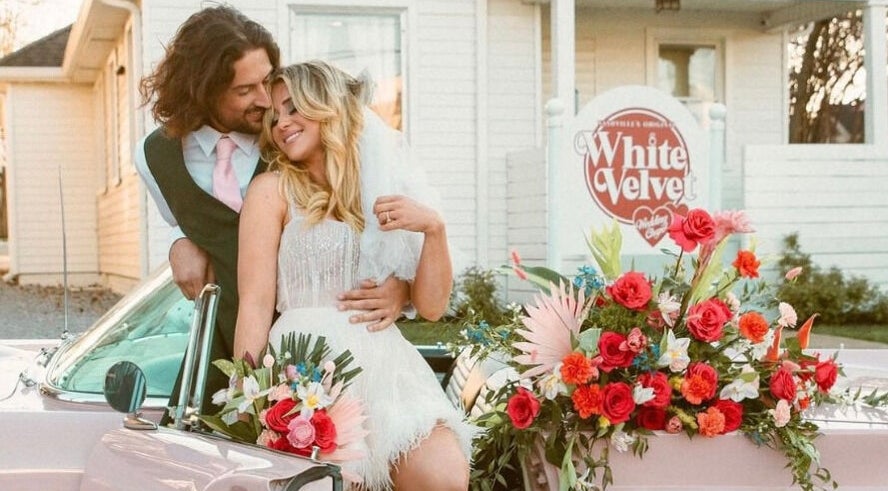 A couple embraces in a floral-decorated car at Glam Up Clarksville in Clarksville, Tennessee, US.
