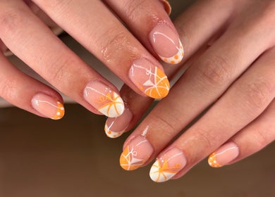 Vibrant orange nail art at Lanny King, High Melton, England, GB. Elegant manicure close-up.