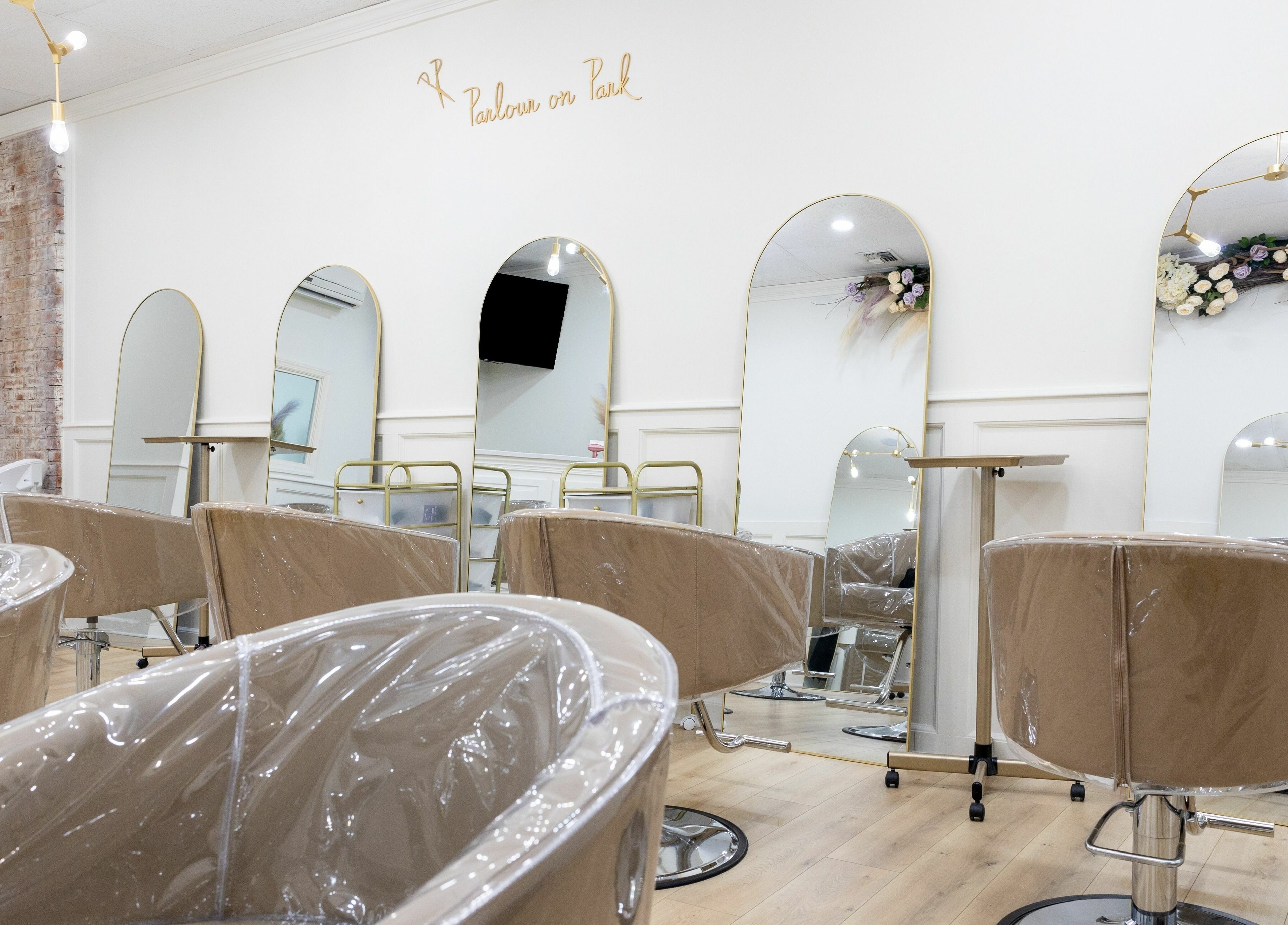 Elegant interior of Parlour On Park in Wantagh, New York, US, featuring stylish salon chairs and decorative mirrors.