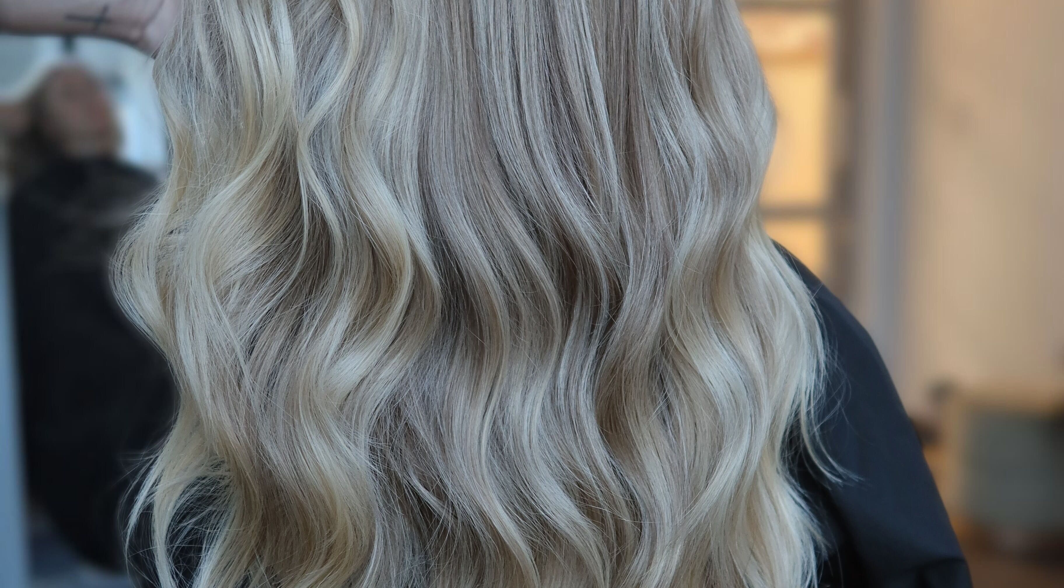 Flowing golden blonde hair styled at Blondie in Durham, North Carolina, US.