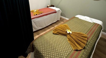 Relaxing massage beds at Pure Massage - Greytown, Wellington Region, NZ, showcasing elegant linens and decor.