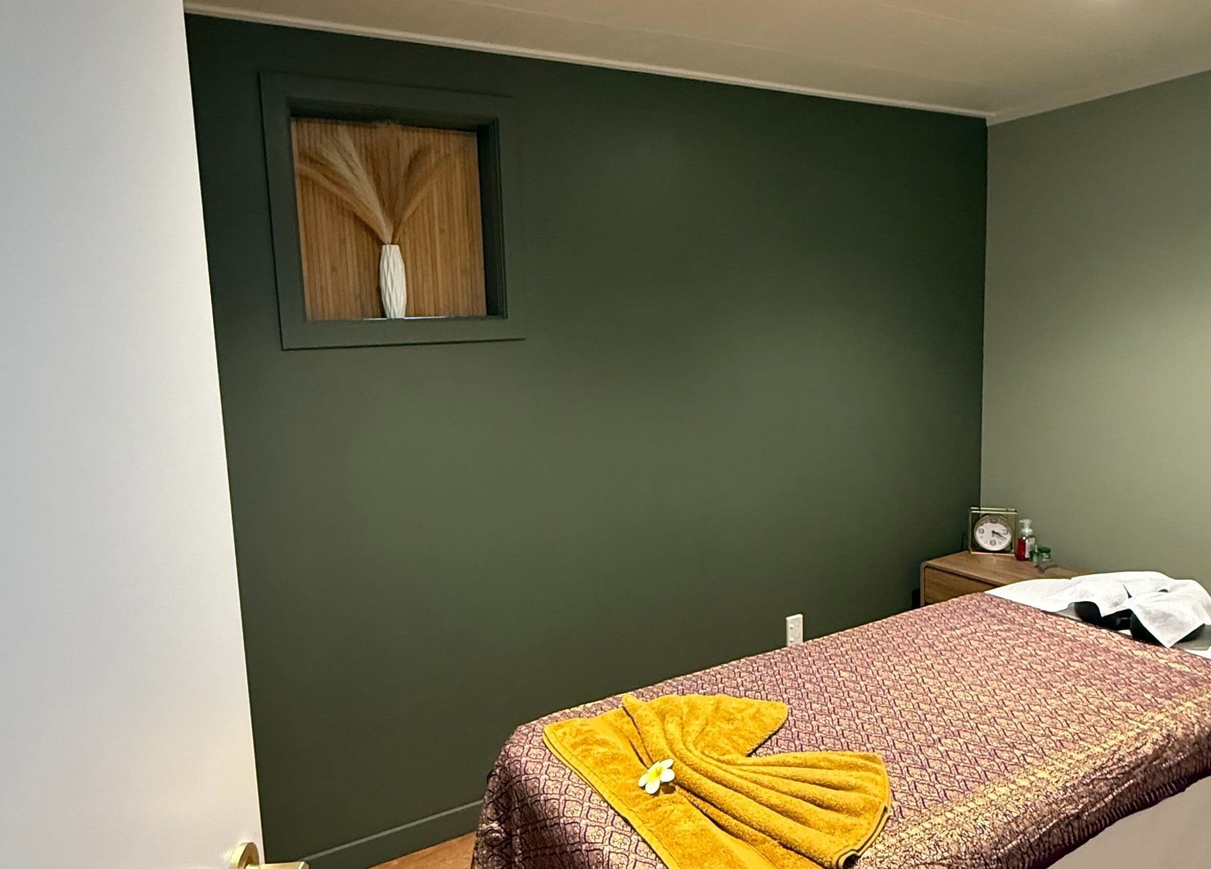Calm massage room at Pure Massage - Greytown, Wellington Region, NZ, featuring elegant decor and service-ready table.