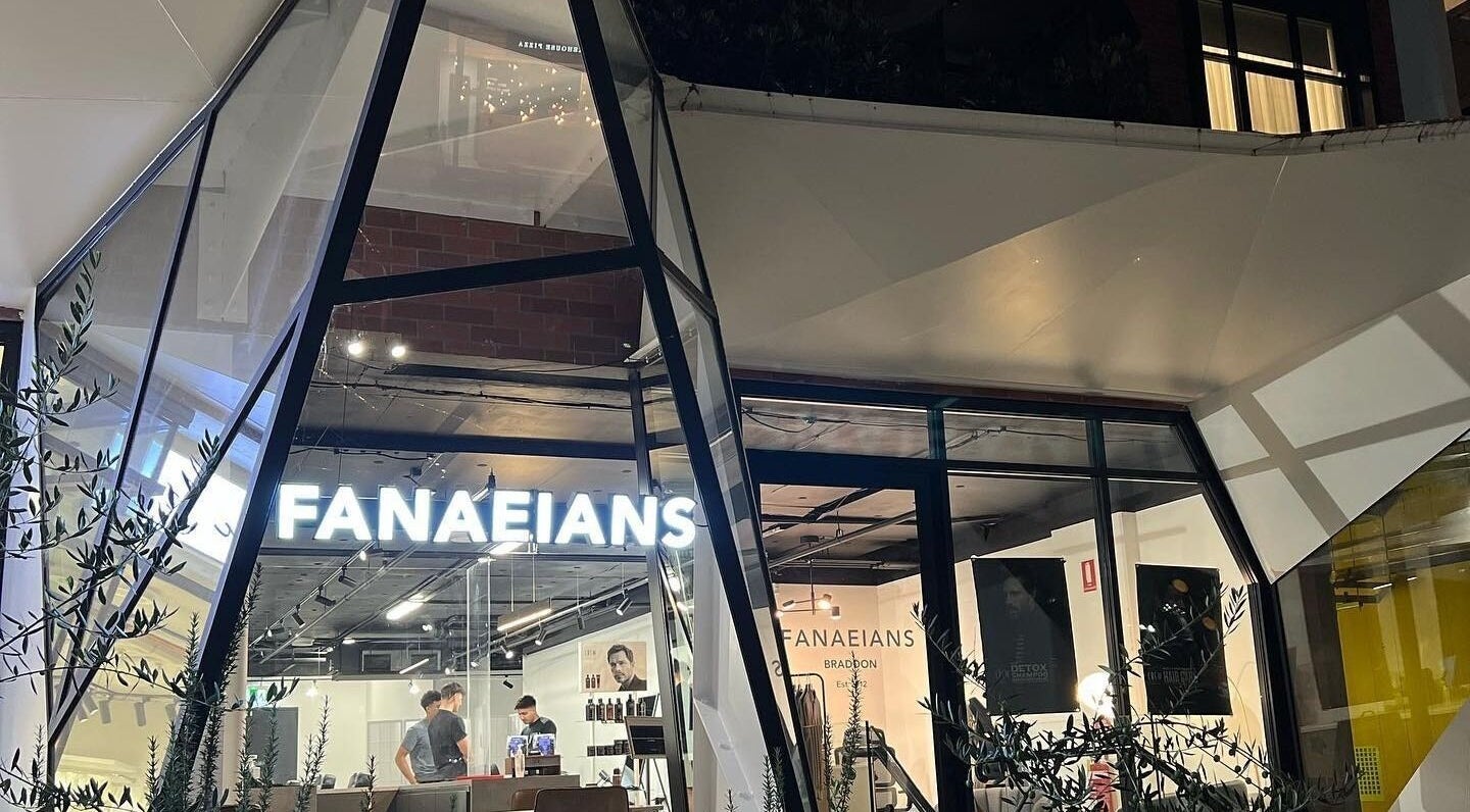 Exterior view of Fanaeians Barbershop in Braddon, ACT, AU with illuminated signage and modern design.