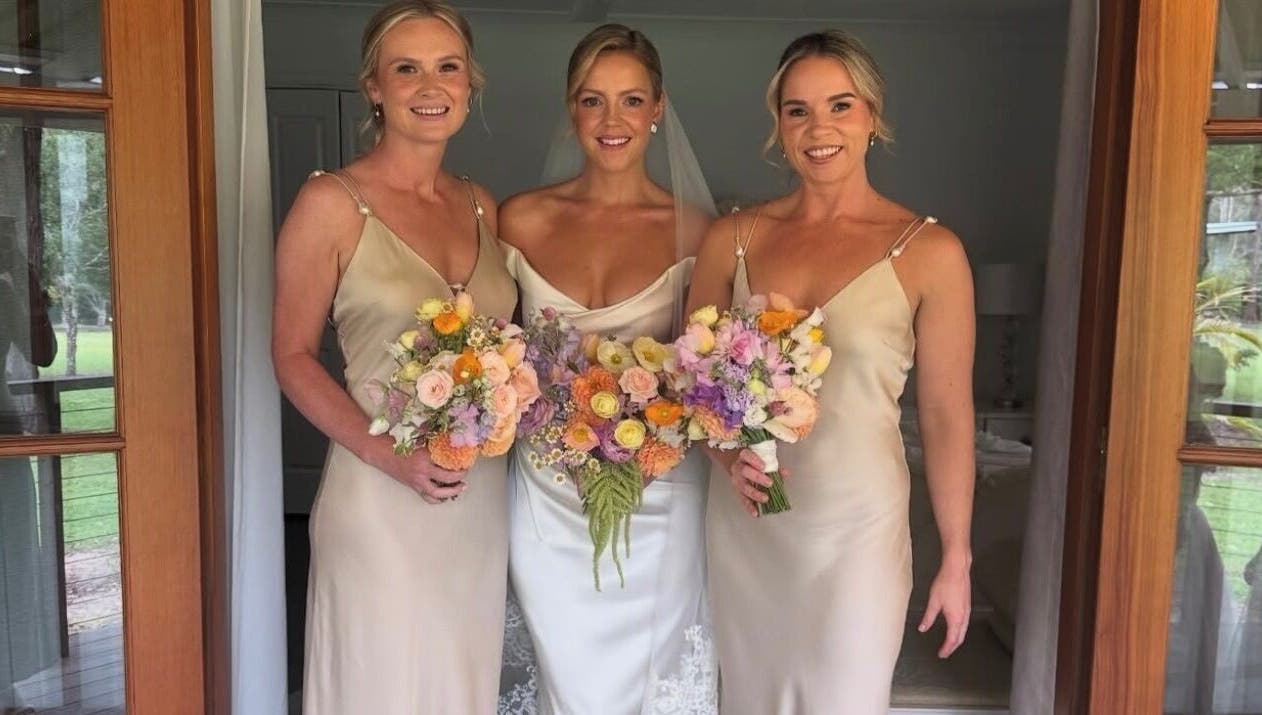Smiling bridesmaids with bouquets at TC Spray Tans, Nerang, Queensland, AU.