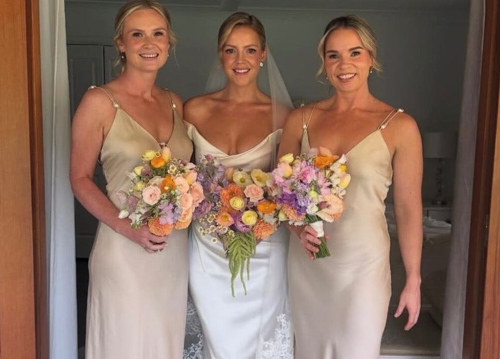 Smiling bridesmaids with bouquets at TC Spray Tans, Nerang, Queensland, AU.